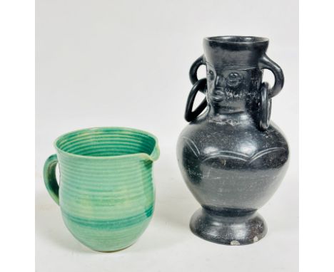 A handmade pottery ribbed green glazed 1930s style jug with C scroll handle to side, (h: 14cm x 13cm) shows no signs of damag
