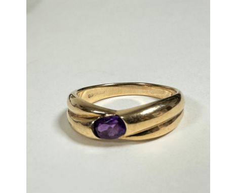 A 9ct gold double cross over ring set oval amethyst approx 0.2ct, (Q/R) (4g) complete with original purchase receipt from Jam