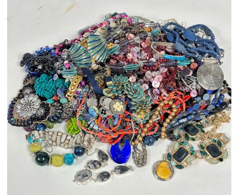 A large collection of costume jewellery including bead necklaces, a lapis oval bead necklace, an enamelled clip on fan shaped