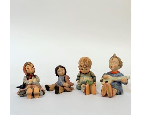 A group of four Hummel seated figures comprising "Happy Pastime", "Friend or Foe", "Joyful" and Goebel Figure by Nina Marco o