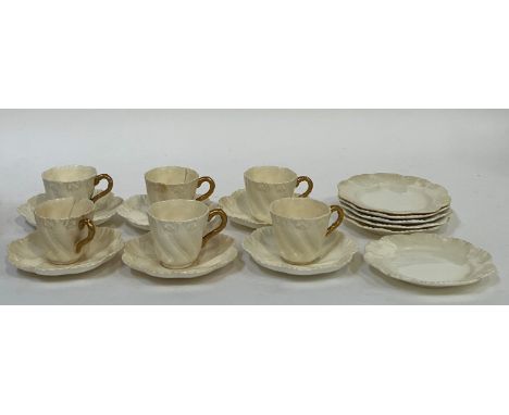 A set of Coalport cream coloured teacups and saucers comprising six gilt handled cups (chipped, cracks) and saucers and six s