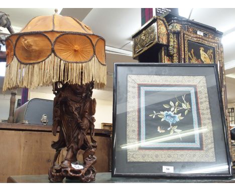 An oriental carved table lamp and a framed silkwork (2) Condition Report: Available upon request