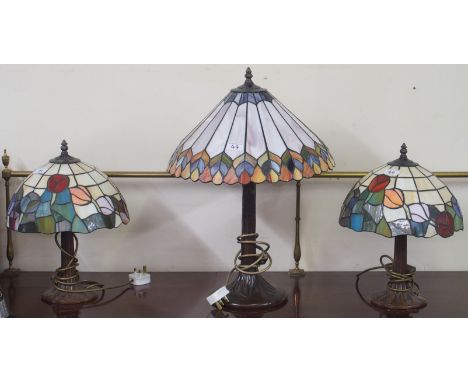 A pair of Tiffany style table lamps and a larger Tiffany style table lamp (3) Condition Report: Available upon request