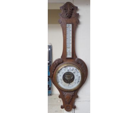 A Victorian carved oak aneroid thermometer/barometer Condition Report: Available upon request