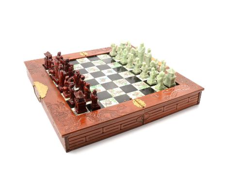 Chinese simulated jade chess set, in a folding chessboard, width 46cm; and a collection of masks and other novelties.