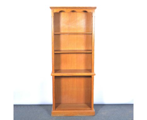 Modern oak open bookcase, dentil cornice above two open shelves to the upper section, with a single adjustable shelf to the l