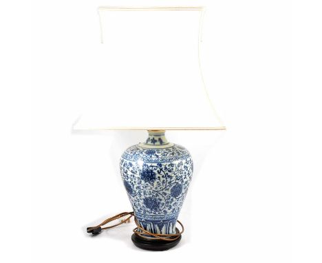 A Chinese blue and white vase, 35cm, serving as a lamp base, complete with shade; and two other lamp bases.