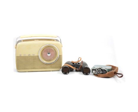A pair of Swift Audubon H.R. 8.5x.44 binoculars; a Bauer 88B cine-camera, in suede pouch; and a Bush type TR transmitter radi