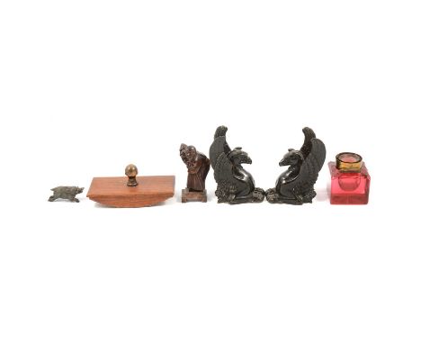 A desk blotter, eagle paperweight and another, pair of patinated art metal bookends in the form of Griffins, cranberry inkwel