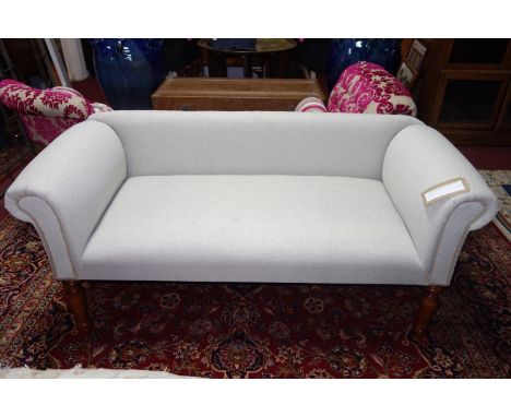 A contemporary sofa, stone linen upholstery, raised on turned legs, H.64 W.134 D.55cm 