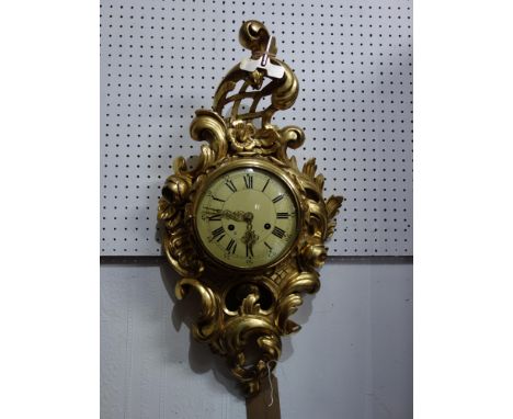 A Dutch gilt wood Cartel style wall clock, the round convex dial with Roman and Arabic numerals, the case decorated with scro