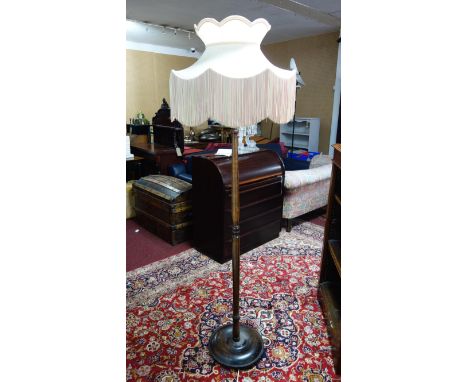 A mahogany standard lamp with pink shade 