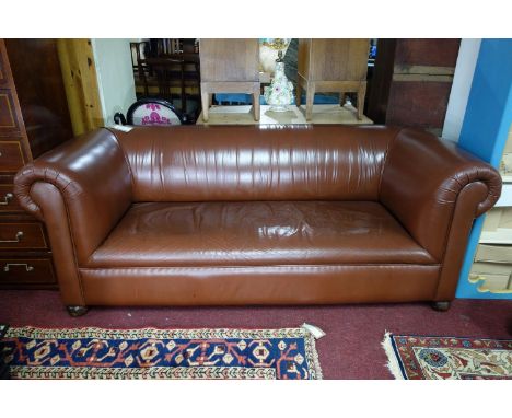 An Edwardian brown leather chesterfield sofa, raised on castors, H.75 W.191 D.88cm 