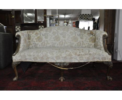 A 19th century George I style mahogany camel back sofa, with floral upholstery, raised on cabriole legs and claw feet, H.93 W