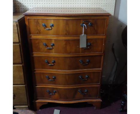 A yew wood chest of five drawers raised on bracket feet, H.104 W.74 D.44cm 