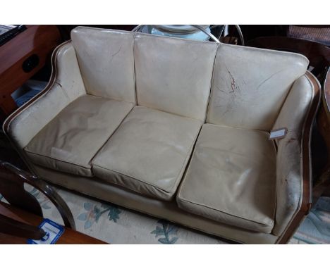 An Art Deco cream leather and walnut sofa 