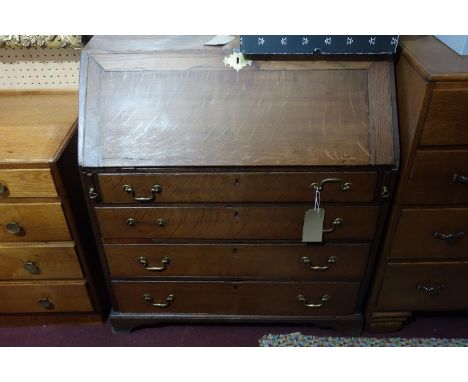 A 19th century oak bureau with four drawers raised on bracket feet, H.100 W.90 D.48cm 