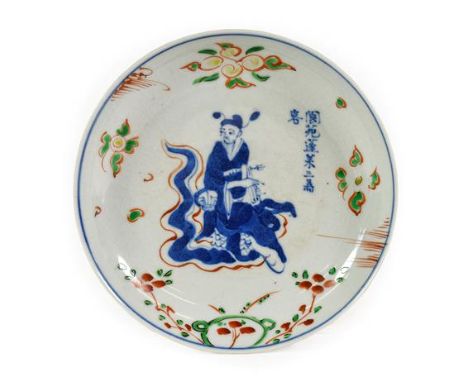A Chinese Porcelain Saucer Dish, 17th century, painted in underglaze blue and green, yellow and red enamels with a figure sea