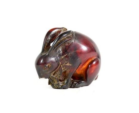 A Japanese Amber Netsuke, Meiji period, naturalistically carved as a crouching rabbit, 5cm longSome surface scratching. 