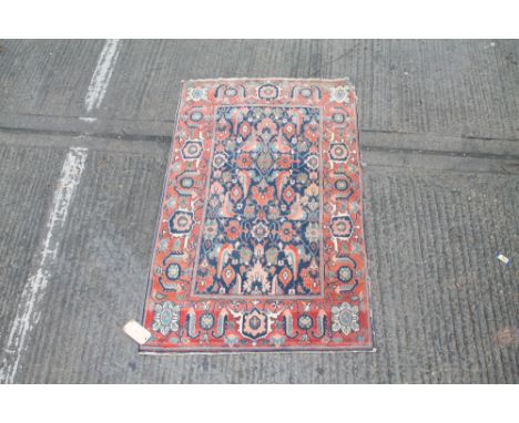 Good early Persian rug with allover flower head and branchwork motifs on navy blue ground within conforming border    CONDITI