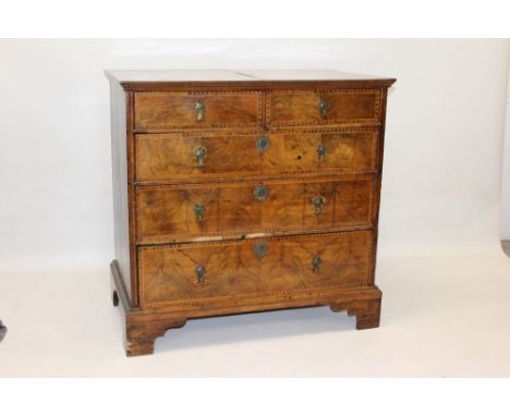 Early 18th century walnut crossbanded and seaweed marquetry inlaid chest of drawers with quarter-veneered top and two short o
