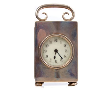 Edwardian carriage clock with eight day movement and lever escapement, white enamel dial with Arabic numerals in a silver cas