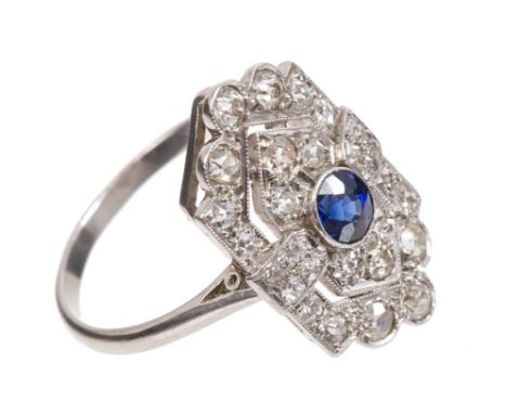 Art Deco sapphire and diamond plaque ring, the shield-shape openwork plaque with a round mixed cut blue sapphire to the centr