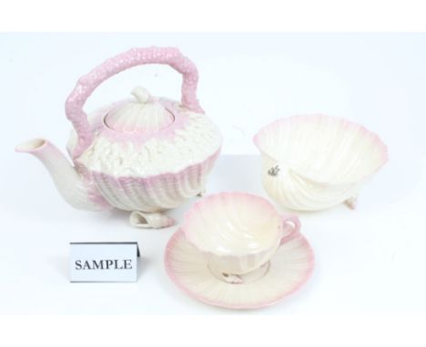 Belleek porcelain shell-shaped pink lustre teaware - comprising teapot and cover, on shell feet (1926 - 1946 mark), large sug