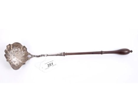 George II silver toddy ladle of scalloped form, with side pouring lip and embossed fruit and floral decoration, engraved init