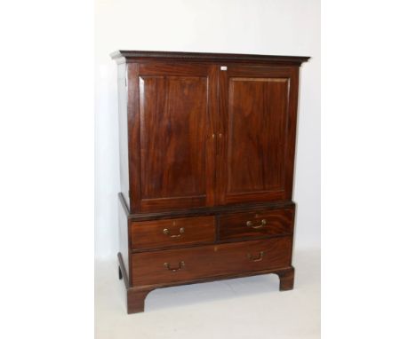 George III mahogany linen press on chest with Greek key pediment, two panelled doors enclosing hanging space, with two short 