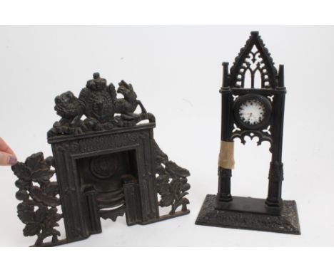 Unusual early 19th century cast iron miniature fireplace with grate and cast Royal Arms and floral scroll decoration, 28cm hi