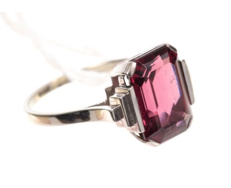 Art Deco pink / red single stone ring, the step cut stone measuring 11.75mm x 7.85mm, with stepped shoulders on plain shank s