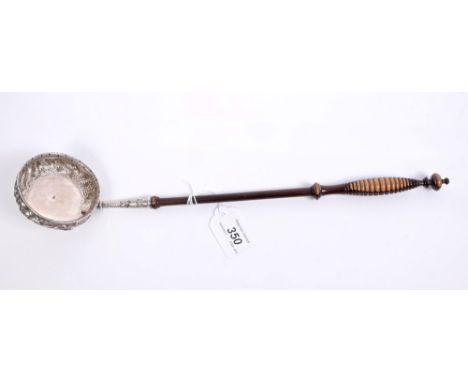 Fine quality early 19th century silver toddy ladle of circular form, with embossed panels of birds and animals against a land