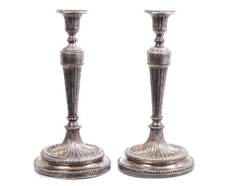 Pair late 18th / early 19th century Continental white metal candlesticks in the neoclassical style, with fluted stems, beaded