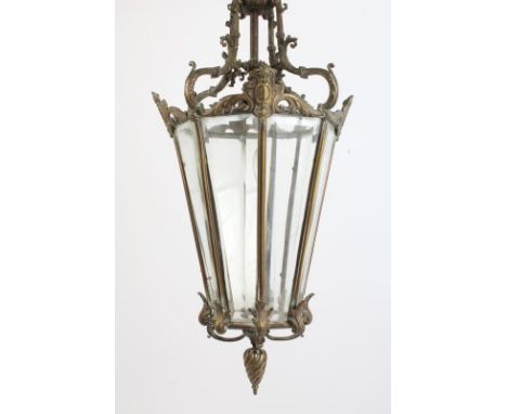 Late 19th / early 20th century bronze ceiling lantern, the tapering octagonal lantern with faceted glazed sides and scrolling