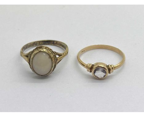 A 9ct Gold Opal Ring, rubover set to centre (small chip), between bifurcated shoulders, with another 9ct gold rubover set rin
