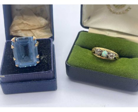 An Antique Style 18ct Gold Three Stone Ring, opal set to centre with diamond side stones, cathedral set between a tapered ban