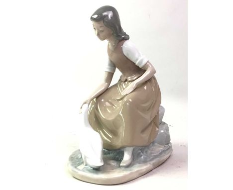 GROUP OF NAO FIGURES, AND A LLADRO FIGURE including a dog group, girl with duck and others, as well as a Lladro figure of a g