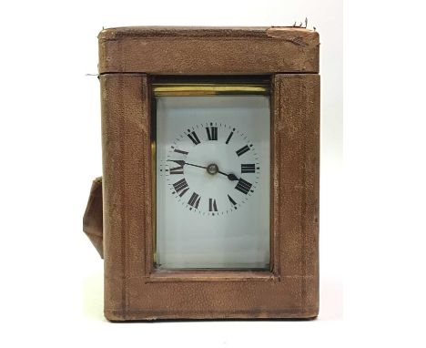 BRASS CARRIAGE CLOCK, EARLY 20TH CENTURY  the white enamel dial with numerals in black, along with a key and travel casethe c
