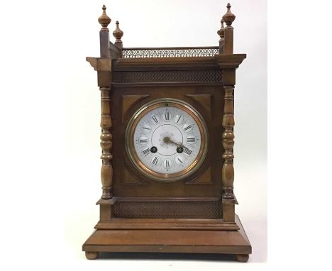 WALNUT MANTEL CLOCK, ALONG WITH AN AMERICAN CLOCK  the mid 20th century walnut clock with pierced brass gallery over a circul