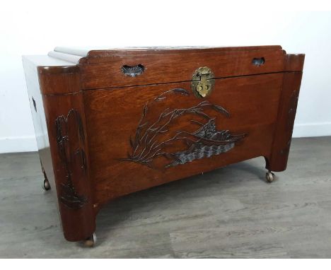 CHINESE CAMPHORWOOD BLANKET CHEST, with carved design on castors60cm high, 102cmwide, 55cm deep 