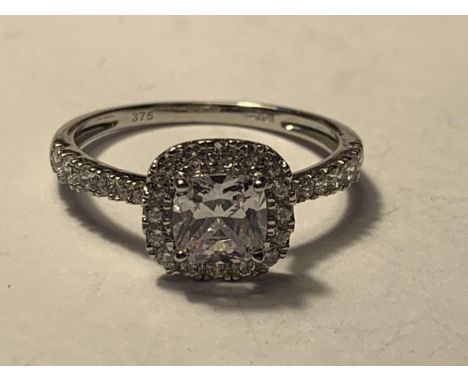 A 9 CARAT WHITE GOLD RING WITH A LARGE SQUARE CUBIC ZIRCONIA ALSO SURROUNDED AND ON THE SHOULDERS SIZE Q/R 