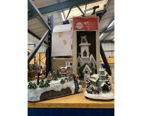 A LIGHT UP WOODEN SNOW HOUSE, AN ILLUMINATED ICE SKATING SCENE AND AN ILLUMINATED CHRISTMAS CHURCH 