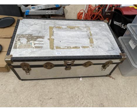 A LARGE HARD CASED TRAVEL TRUNK 
