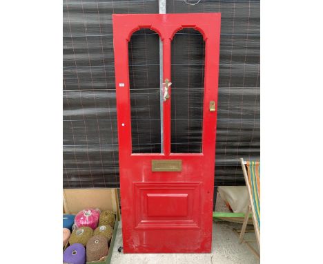 A WOODEN EXTERNAL DOOR WITH BRASS LETTER BOX AND KNOCKER 