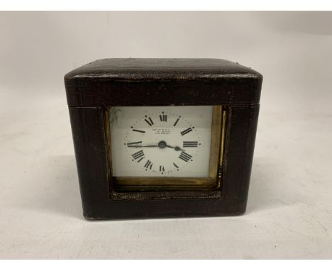 A VINTAGE BRASS CARRIAGE CLOCK IN A LEATHER TRAVELLING CASE 