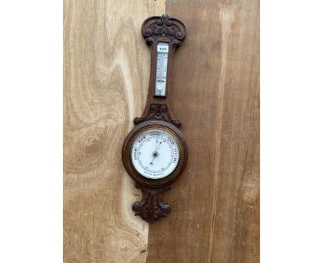 A VINTAGE OAK CASED ANEROID BAROMETER 
