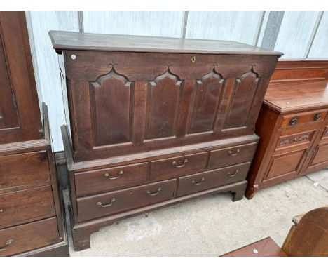 A GEORGE III WELSH OAK BLANKET CHEST WITH FOUR PANEL FRONT ON BASE, ENCLOSING THREE SHORT AND TWO LONG DRAWERS, 57" WIDE 