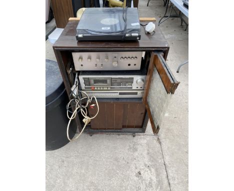 A PYE STEREO CABINET WITH AN ASSORTMENT OF STEREO ITEMS TO INCLUDE A SANSUI AMPLIFIER AND AN OPTONICA TUNING PROCESSOR ETC 