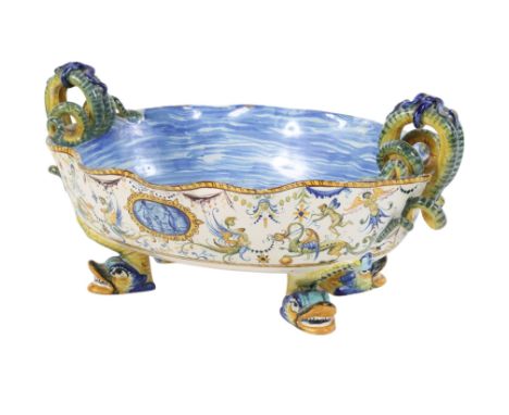 An Italian Cantagalli oval footed bowl. With serpent handles, decorated with mythological figures, on three animal headed fee